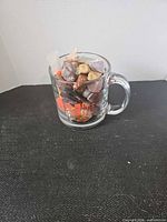 Glass mug filled with assorted stones