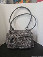 Front view of Minicci handbag showing pattern, handles and pockets