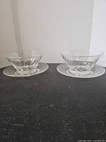 pair of crystal bowls on matching underplates