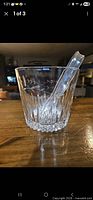 Front view of crystal ice bucket with tongs inside