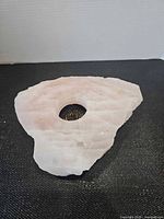 Top view of rose quartz slab showing central cavity with flower frog