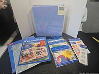Full lot view showing album, book, sheet protectors, embellishments, scissors, sticker sheet
