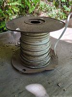 Full view of cable wound on rusted metal spool