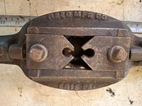 Close view of Reed Mfg Co. threader head showing jaw blocks and fasteners