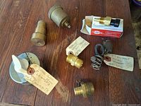All six automotive pressure parts laid out on wood surface