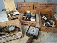 Overview of wooden boxes containing assorted gauges, sensors, switches