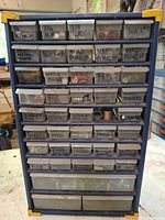 Front view of blue organizer showing labeled drawers