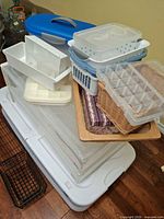 Stack of under-bed totes, stack drawers, small organizers and wicker trays