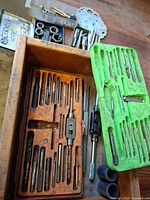 Drawer with plastic trays full of taps, tap wrench, die stock, loose dies, gauge, insert boxes