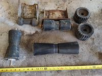 Group shot of all rollers and brackets on floor with tape measure for scale