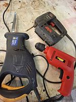 All three corded power tools on workbench