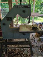 Full view of Delta 16-inch band saw on stand with blade and table visible