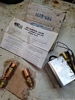 Actuator, two copper fittings, installation bulletin and T65-4221 box on workbench