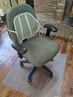 Front view of gray-olive office chair with attached mesh lumbar support on clear floor mat
