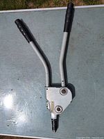 Full view of rivet tool, handles extended