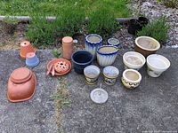 Group shot showing all planters, saucers, mosquito burner and sundial