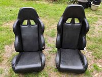 Front view of both black racing seats showing upholstery and overall condition