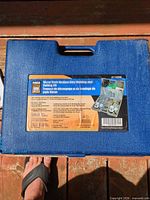 Closed blue carrying case showing Power Fist label