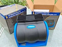 Fan outside its box beside second boxed unit