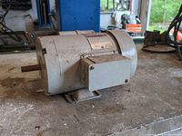 Left side view showing shaft, foot mount, junction box and overall housing