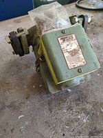 Overall view of green Taco circulator pump showing housing and electrical box