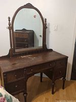 Full view of dresser vanity with attached mirror