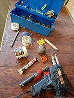 Overall lot showing soldering gun, pencil iron, solder spools, flux tube, blower and toolbox