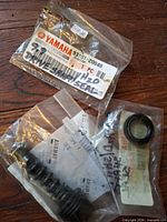 Overall view of three Yamaha parts in sealed bags showing labels and contents