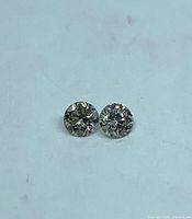 Pair of loose round diamonds side by side