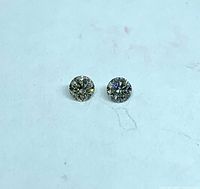 Two loose round diamonds on flat background