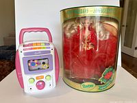 Front view of Barbie karaoke cassette player and sealed Happy Holidays Barbie doll