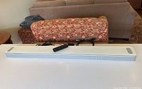 Top view of Bose Smart Soundbar 900 with remote and cables