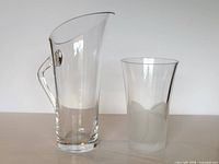 Pitcher and vase side by side showing size and design