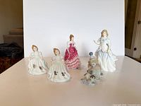 Group shot of five Royal Doulton lady figures and one Lladro clown with dog