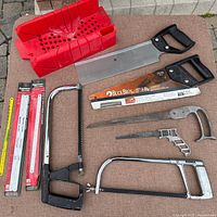 Overall lot: mitre box, two back saws, two hacksaw frames, loose blade, packaged replacement blades