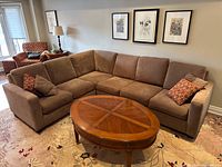 Front view of assembled L-shaped sectional with coffee table, showing color, cushions and overall style