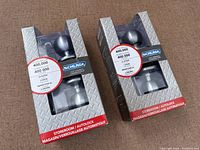 Two boxed Schlage storeroom/auto-lock knobsets
