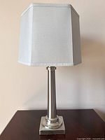 Full view of table lamp showing base, column and shade