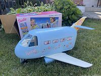 Jet airplane exterior with original box behind on lawn