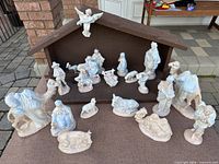 Front view of manger with full porcelain nativity set displayed