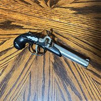 Left side view of derringer-style replica pistol lighter showing barrel, grip and trigger