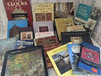 All 18 books arranged upright and flat, showing front covers and titles