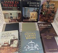 All nine books front covers visible on patterned cloth
