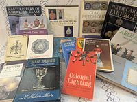 All 18 decorative arts reference books spread out, front covers visible