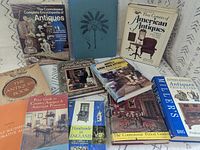 All 11 antique reference books laid out showing covers