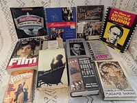 Front covers of all 12 books laid out on fabric backdrop