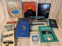 Front view of all 13 earth science and geography books laid out