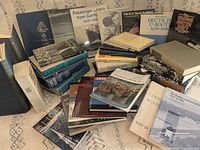 Entire assortment of approximately 33 war, naval and maritime history books spread out on surface