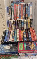 Full lot stacked showing majority of VHS spines and fronts