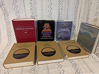 Front view of all seven books upright showing spines and covers